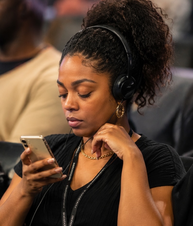 A person following along on their phone with headphones