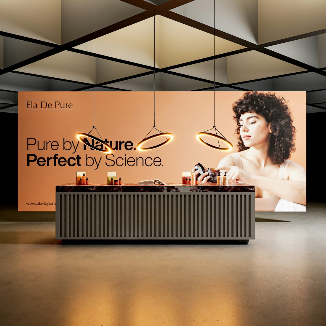A trade show stand: a wide printed backdrop with a headline and product photography, and a counter in front of it